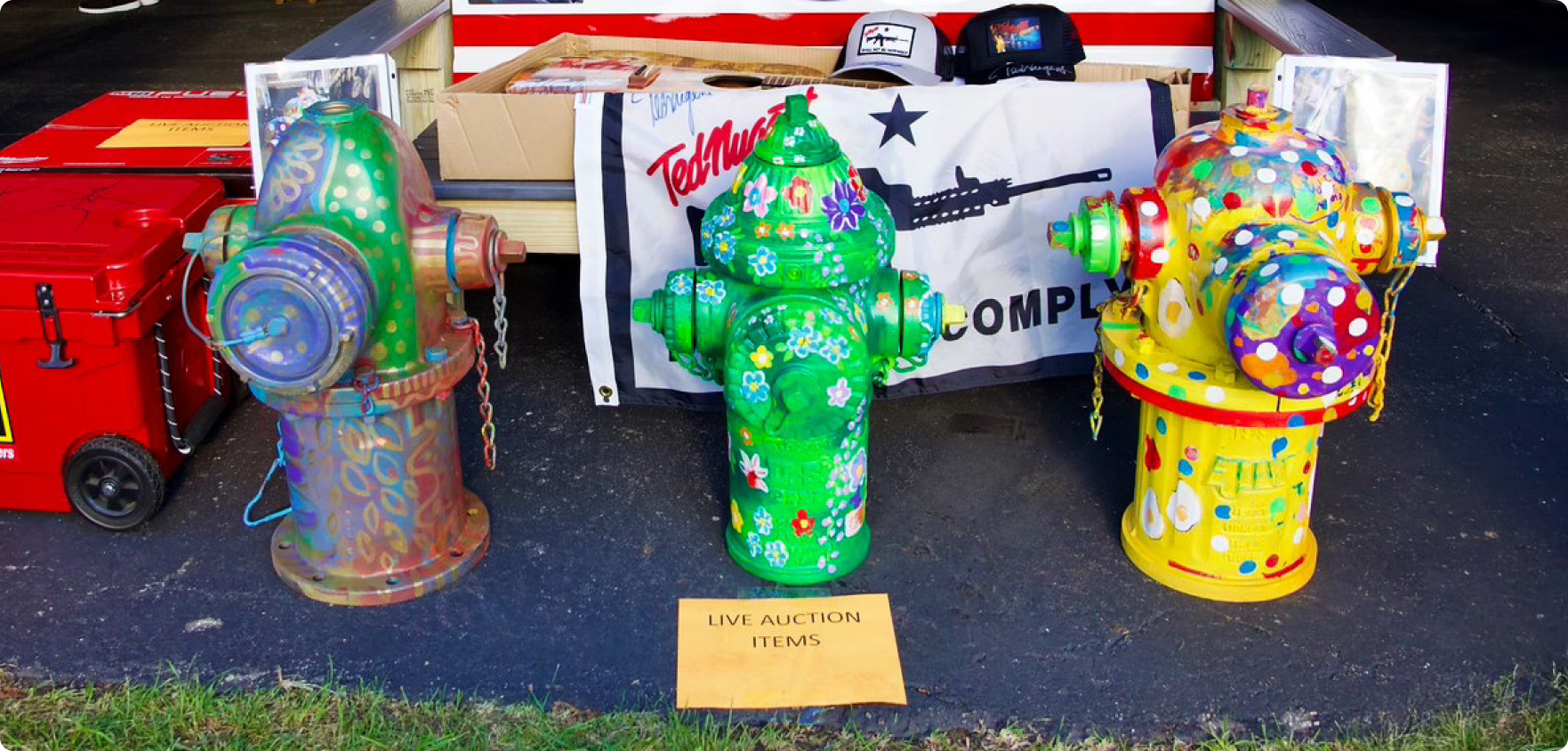 Painted fire hydrants out as live auction items.
